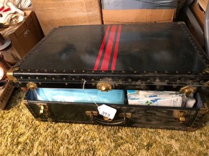 Metal trunk with new blankets, pillowcases, sheets