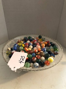 Glass bowl with assorted marbles