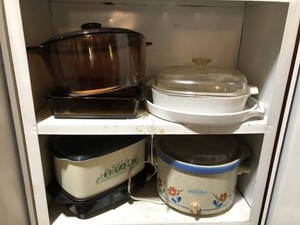 Corningware, glass baking dishes, crock pots all on 2 shelves