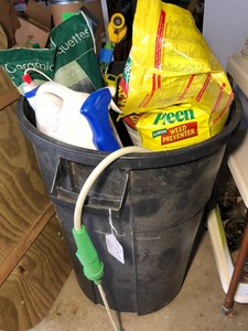 Rubber container with lawn and garden supplies and sprayers