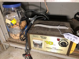 Sears battery charger, Homelite trimmer, Skilsaw all on bottom shelf