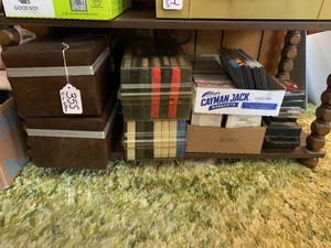 Assorted 8 tracks, DVDs, cassette tapes all on bottom shelf