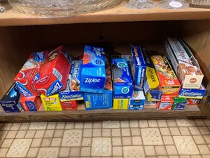 Kitchen wax paper, Ziploc bags, slow cooker liners and more some open all on bottom shelf