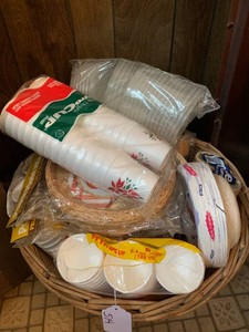 Wicker basket with plastic dinnerware items