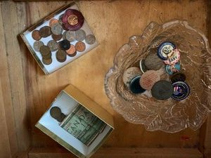 Tokens, foreign money, pennies and nickels all in drawer