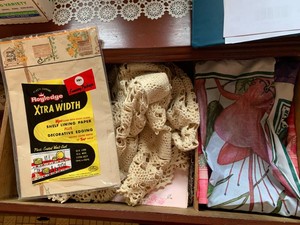 Crocheted items, decorative shelf paper, candles all in 2 drawers