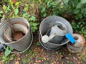 Metal pails, sprinkler, shovel, gas can