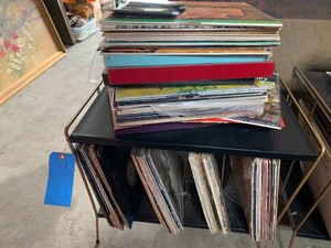 Assorted vinyl records and metal stand