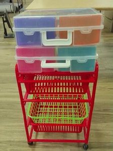 TINY RED CART WITH PLASTIC CONTAINER FULL OF COLORFUL PLASTIC CONTAINERS