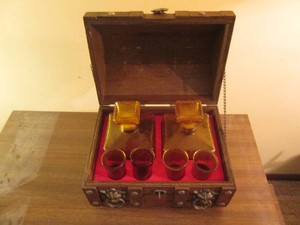 Small wood desktop treasure chest containing depression Era Decanters and matching shot glasses