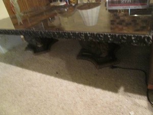 Vintage coffee table with dual carved pedestal style base plus Black and gold metallic resin swirl style surface approx 60x31x15in