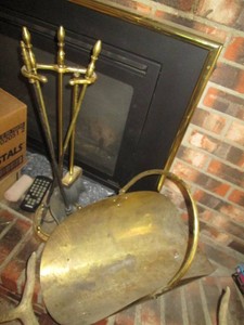 Brass tone fireplace log holder with matching fireplace cleaning tool set