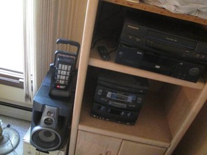 VHS and DVD players, Sharp bookshelf radio with (2) speakers and Porter Cable cordless work light