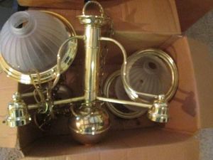Large brass tone pendulum light fixture with frosted glass shades