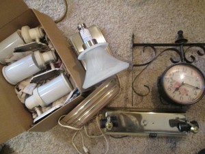 Decorative scroll and floral clock plus misc wall sconce style light fixtures