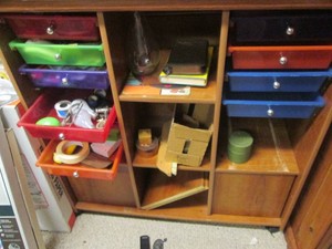 Laminate multi-drawer organizer shelf with household supplies and other content shown