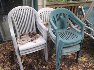 Collection of assorted plastic outdoor patio chairs