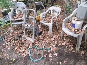 Pair of outdoor hose reels and cluster of outdoor patio chairs