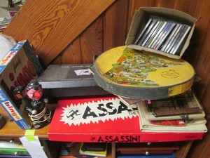 Content on top of shelf to include music CDS, adding machine, receipt books, vintage games and more