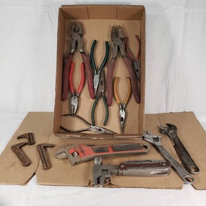 Various Hand Tools including Wrenches, Pliers, and Multi-Tool