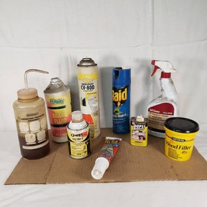 Assorted Cleaning and Maintenance Products including Raid Insect Killer, Minwax Wood Filler, OReilly Brake Fluid - all partially full