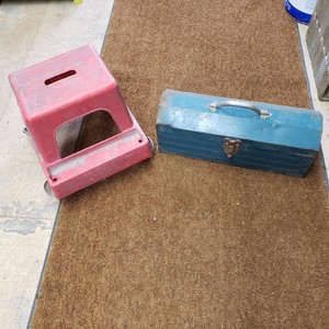 Red Plastic Step Stool and Blue Metal Toolbox