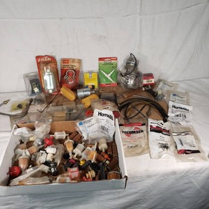 Assorted Engine Replacement Parts Including Tecumseh, Homelite, and Oregon Filters including multiple packaged filters, clamps, hoses, and protective caps