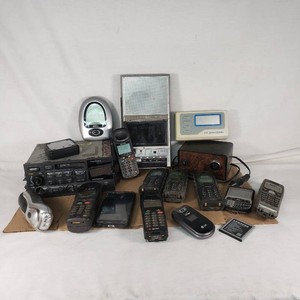 Lot of Electronics and Cell Phones including General Electric Radio, EnGenius Phones, LG Flip Phone, and Samsung Battery