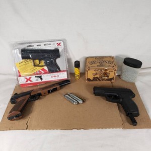 Lot of BB Guns and Accessories Including Daisy Power Line Model 1200 CO2 BB Pistol, Umarex Action Pistol, BBs, and CO2 Cartridges