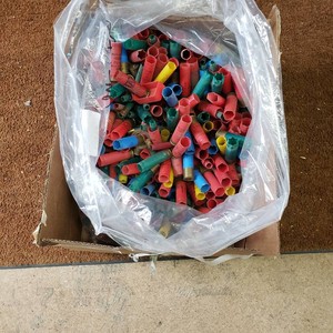 Bag of Spent Shotgun Shell Casings in Cardboard Box