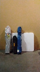 3 folding up chairs and a plastic folding table