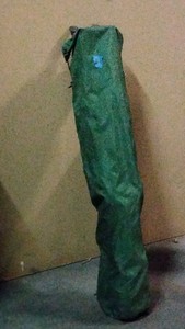 folding chair in green bag