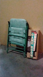 green folding chair and game room wall decoration