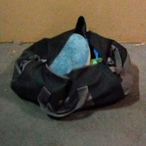 Duffel bag full of rags and cleaning supplies