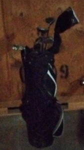 PowerBilt Black and white golf bag with clubs