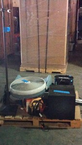 pallet of electronics, fans, and a lamp