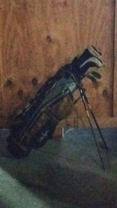 Black and yellow golf bag with clubs