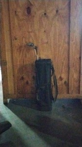 Black golf bag with 2 clubs