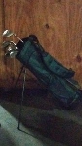 green golf bag with 9 clubs