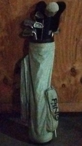 white PING golf bag with 16 clubs