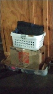 boxes of clothes and laundry baskets of pictures