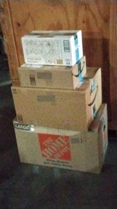 boxes of pots, pans, bowls, and books