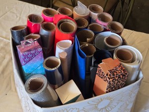 Rolls of Cricut Craft Supplies including StrongBond and Infusible Ink Materials and Vinyl