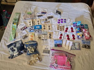 Lot of crafting supplies including various buttons, ornaments, and findings