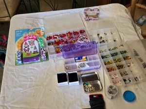 Lot of crafting supplies including Perler Fused Bead Kit, assorted beads, wires, and crafting tools.