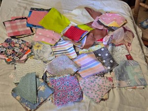Lot of Assorted Fabric Quilt Squares in Various Patterns and Colors