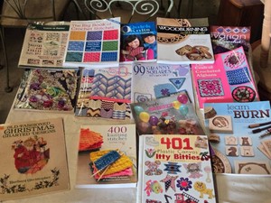 Craft book collection including The Big Book of Crochet Stitches, Quick Knits, Woodburning with Style, and others focusing on crochet, knitting, woodburning, painting, and crafts.