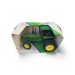 116 scale Ertl John Deere 4850 die-cast tractor (Stock #584DA), complete with a cab, front-wheel assist (FWA), and dual rear wheels in its original box.