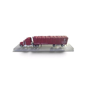 164 scale die-cast J.J. Keller & Associates tractor-trailer modelspecifically a red semi-truck cab pulling a red covered-wagon (roll-tarp) flatbed trailer featuring the J.J. Keller logo and contact details