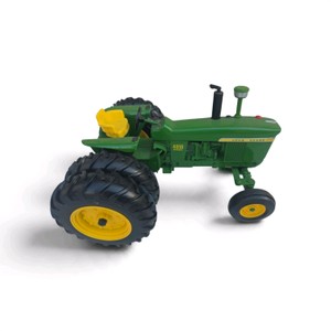 green-and-yellow John Deere 4010 Diesel toy tractor in 116 scale, featuring a wide front axle and dual rear wheels.